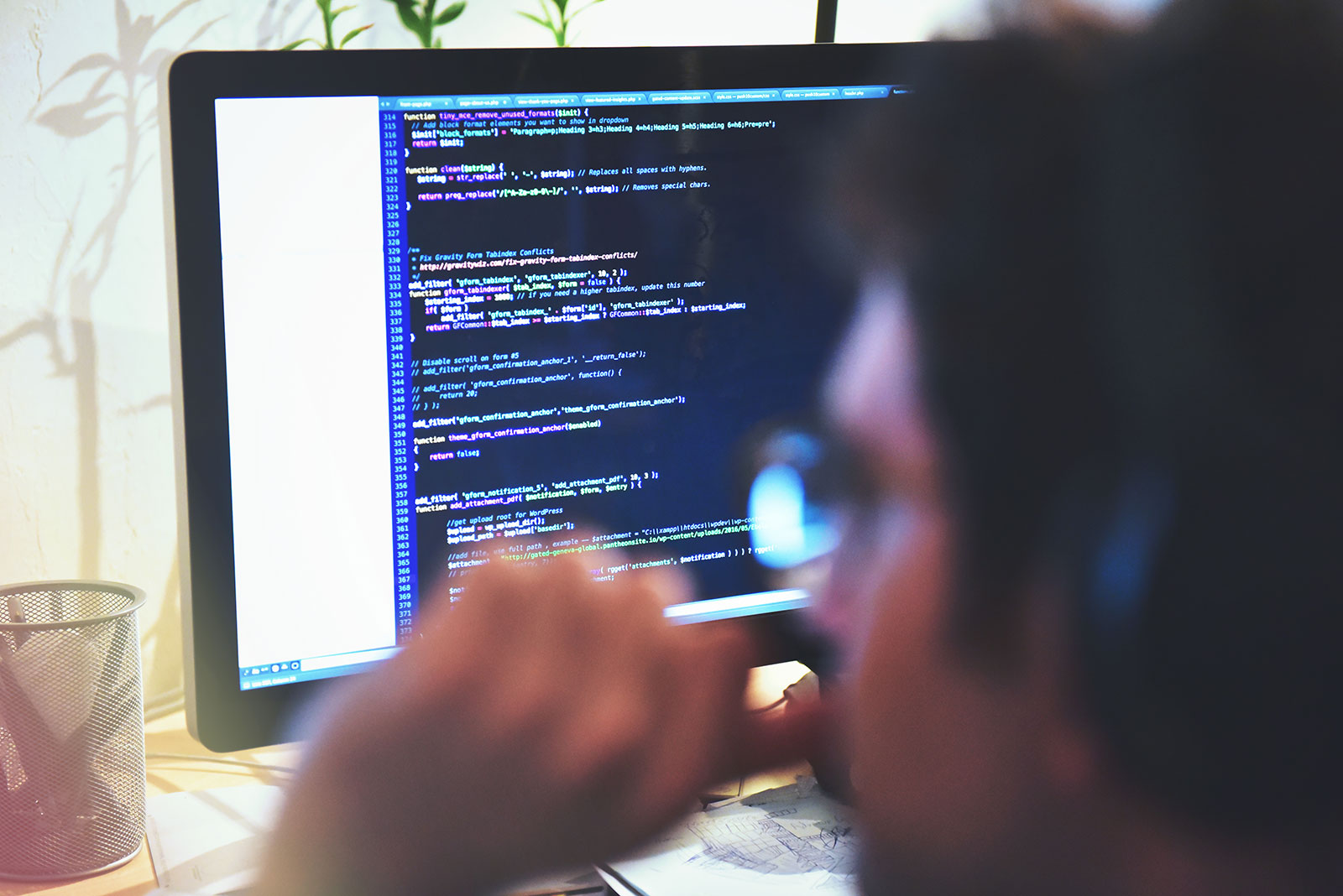 AEC web developer on his computer working on web development code.