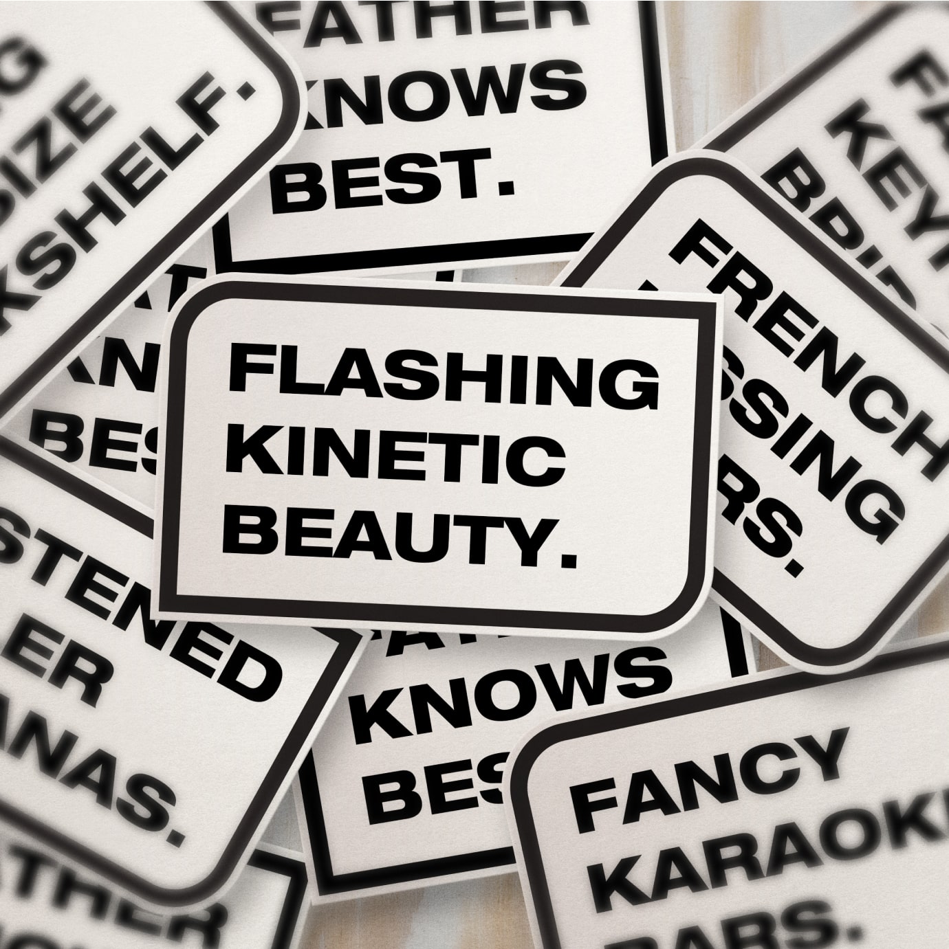 Pile of stickers with a variety of phrases all starting with the letters F,K, and B for FKB's architecture branding.