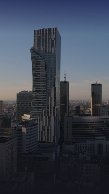 A view of a city skyline with towering buildings during twilight.