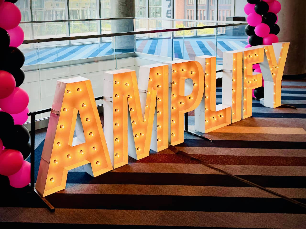 Amplify AEC standing letters outside entrance to conference room at the Hyatt Regency in Salt Lake City, UT attended by Third & Arch a AEC Branding Agency.